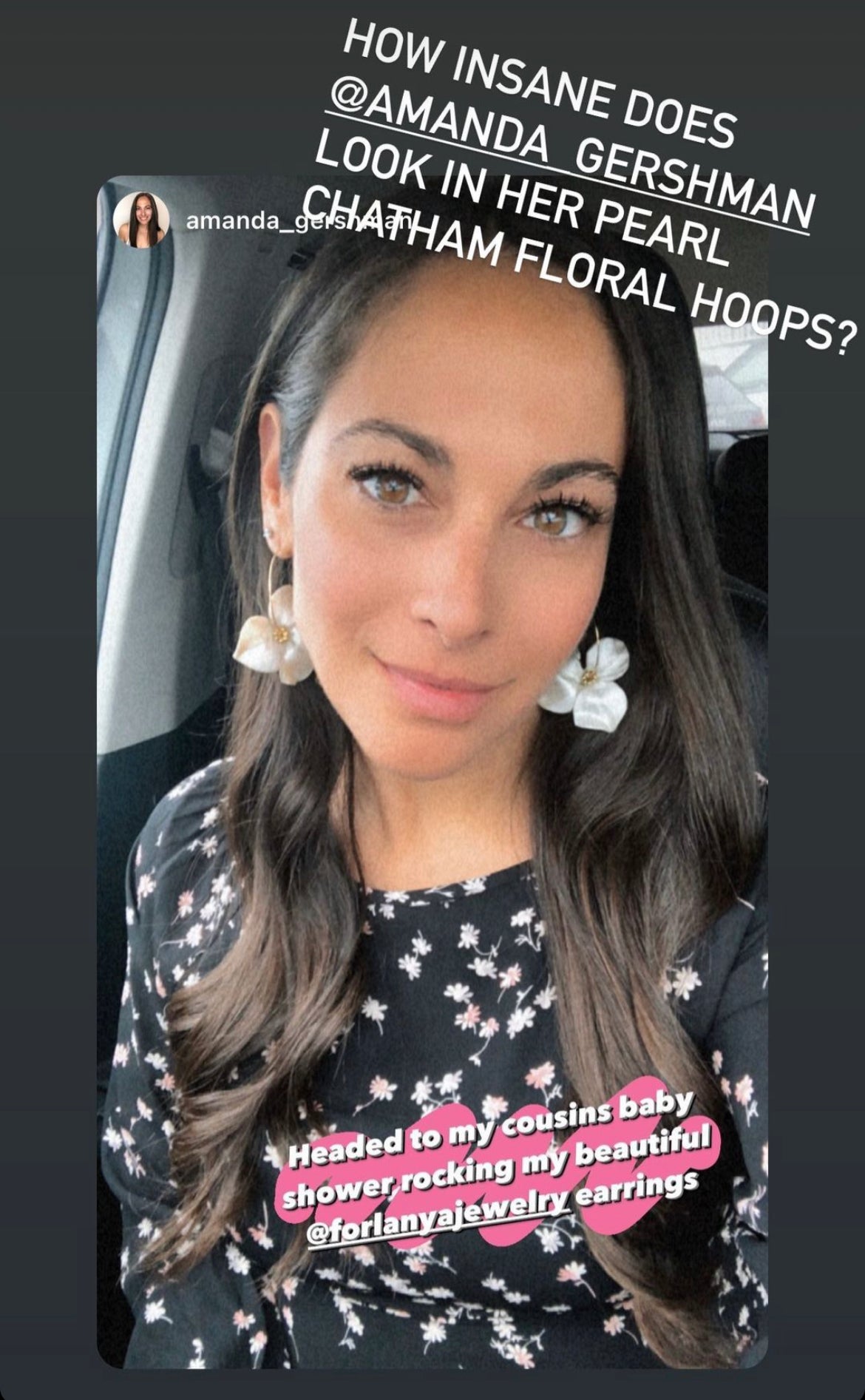 Woman wearing pearl floral hoop earrings and a flower patterned black dress